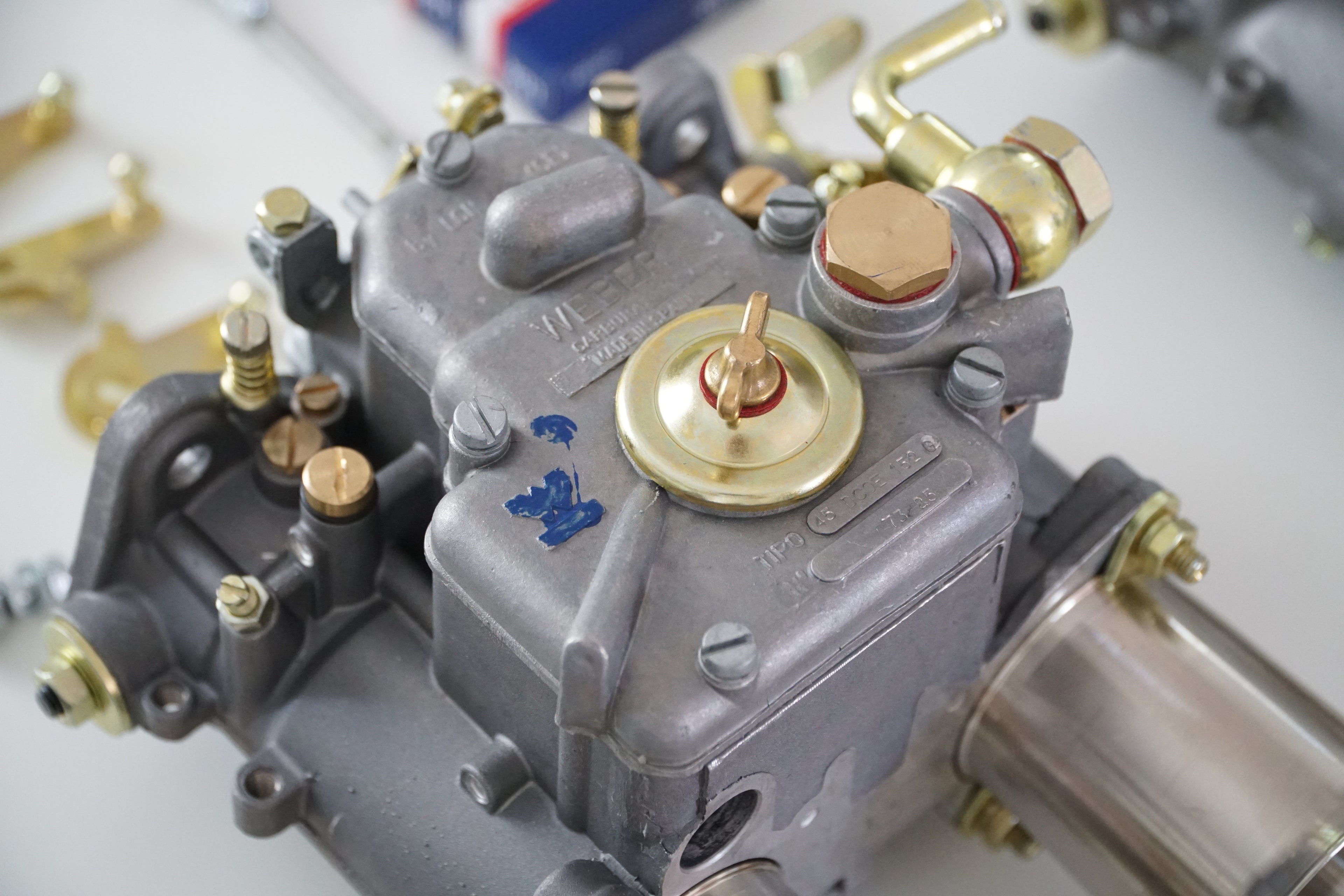 Close up of Weber 45 DCOE 152G on white table from above