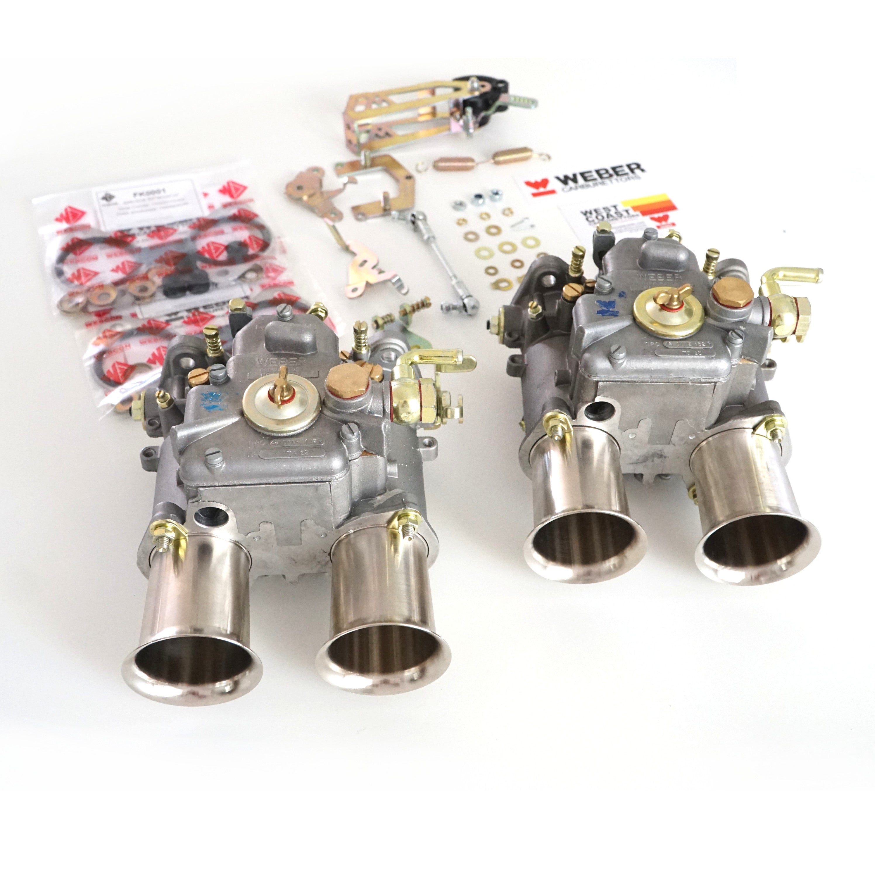 Two Weber 45 DCOE 152G carburettors on a white table with LP1000 linkage kit and soft mounts